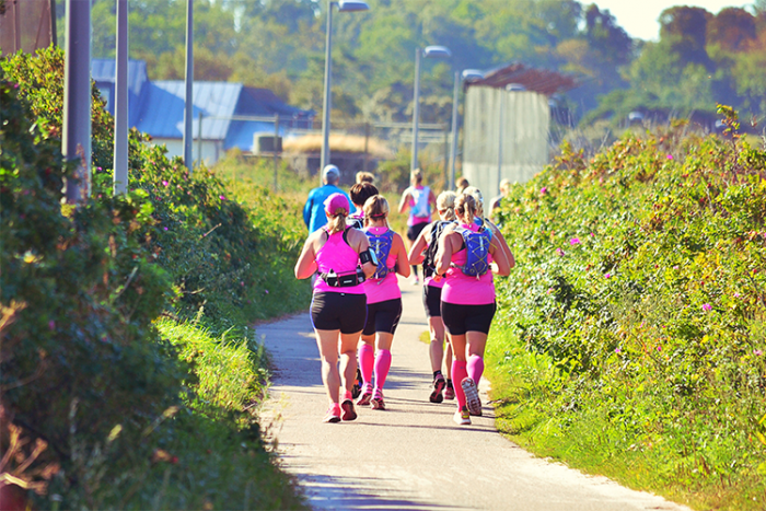 women in pink shirts running in quebec city
